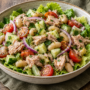 AI illustration of tuna and white bean salad with cucumber, tomatoes, red onion and romaine lettuce.